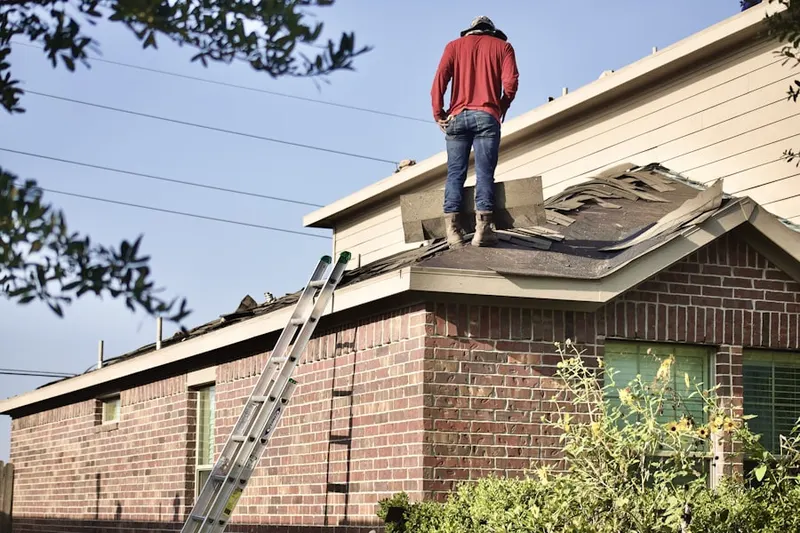 Professional roofer working on a residential roof in Mossy Oaks